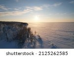 Small photo of Above the snow-covered road to the big river Ob. Cold winter. Drone view. Arctic. Yamalo-Nenets Autonomous Okrug. Russia.