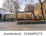 Small photo of Duke of York Square, London, SW1, UK - March 25th 2022: Sign on benches reads 'Duke of York Square', located in the high fashion and art area of Chlesea. Shot on a spring mornign with golden light.
