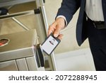Small photo of A man uses an electronic pass to pass through the turnstile. Ensuring the security of the company. Electronic document
