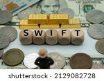 SWIFT.Society Worldwide Interbank Financial Telecommunication.concept of international finance, commerce and banking.table covered with banknotes and gold, dice with the word.