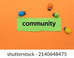 Small photo of community.The word is written on a slip of paper. Emotional nouns, feeling words, emotional phrases. Positive or negative attitudes.