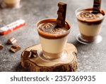 Kinder chocolate cheesecake served in cup isolated on wooden board top view cafe cheese cake food dessert