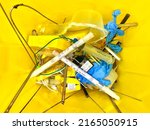 Small photo of LONDON, UNITED KINGDON - June 5, 2022: Surgical Waste in a sharp container used during an orthopaedic procedure. Mostly metals and needles, infectious and a risk for injury.