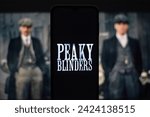 Small photo of Selective focus of the Peaky Blinders drama series logo on a mobile screen. It is a British period crime drama television series created by Steven Knight: Dhaka, Bangladesh- Jan 7, 2024