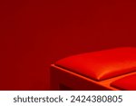 A striking minimalist composition with a rich red hue enveloping a simple object, embodying the essence of color impact and modern interior design with comfort bench furniture in the theatre room