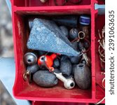 Small photo of Fishing lures and bobbers in a tackle box.