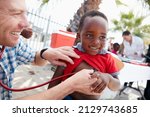 Small photo of Every child deserves a healthy start in life. Shot of a volunteer doctor giving checkups to underprivileged kids.