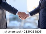 Small photo of First impressions go a long way in business. Shot of two unidentifiable businessmen shaking hands in the office.
