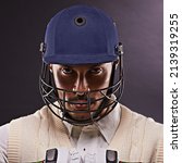 Small photo of Confident in his batting ability. A cropped shot of an ethnic young man in cricket attire isolated on black.