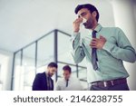 Small photo of Feeling groggy with flu. Cropped shot of a businessman suffering with allergies in an office.