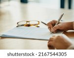 Small photo of Sign on the dotted line. Closeup shot of an unidentifiable businesswoman filling in paperwork in an office.