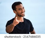Small photo of I know exactly what you need. Shot of a sporty young man smiling while standing outside.