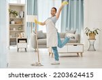 Fun asian woman, mop or cleaning living room with housekeeping floor product for home cleaner service, maid or worker. Happy, smile or healthcare maintenance in bacteria spring clean of interior room