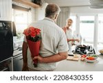 Small photo of Surprise, roses and a senior couple at home with romantic man spoiling wife with a bouquet of flowers on an anniversary, birthday or valentines day at home. Husband hiding gift for a woman behind his