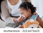Mother clean sick child nose with tissue, playing with toy or teddy bear in bedroom at family home. Teacher at kindergarten use toilet paper, to help clean young girl face after sneeze or runny nose