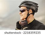 Small photo of Fitness, sports and cyclist checking his helmet before cycling, training, workout and cardio ride in nature. Health, biking and athletic man getting ready for cycle, happy, smile and relaxed training