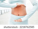 Small photo of Fitness, woman and hands on stomach for digestion health with workout, exercise and training. Gut health, weight loss or diet of active runner girl showing healthy abdomen on cardio break.