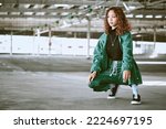 Youth, fashion and black woman with streetwear in an urban city parking lot for design, brand and hip hop lifestyle. Young woman, teenager or fashion model in designer clothes and sneakers outdoor