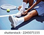 Tennis player woman  shoelace...