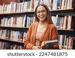 Small photo of Face, student and woman in university in library ready for learning. Portrait, education and happy female from Brazil standing by bookshelf with book for studying, knowledge and literature research.