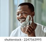 Face, shaving and razor with a black man grooming in the bathroom mirror of his home for beauty or skincare. Beard, shave and blade with a handsome male in the morning for his hair removal routine