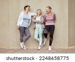 Senior women, exercise and funny with retirement, fitness and wellness, vitality and active lifestyle against wall background. Mature female friends, comedy and training, relax and sports motivation