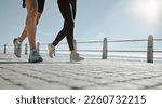 Small photo of People, legs and running at the beach for exercise, cardio workout or training together outdoors. Leg of friends taking run, walk or jog on warm sunny day by the ocean coast for healthy wellness
