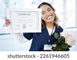 Small photo of Certificate, flowers and portrait with a black woman graduate or nurse in the hospital, proud of her achievement. Smile, graduation and qualification with a happy young female standing in a clinic