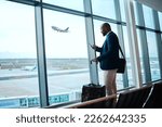 Black man with phone, airport window and plane taking off, checking flight schedule terminal for business trip. Technology, travel and businessman reading international travel restrictions app online