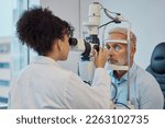 Vision, eye exam and healthcare with a doctor woman or optometrist testing the eyes of a man patient in a clinic. Hospital, medical or consulting with a female eyesight specialist and senior male