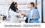Small photo of Business women, handshake and welcome, introduction and hello to new intern while walking in office. Happy, excited and diversity workers shaking hands for support, teamwork or onboarding partnership
