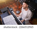 Small photo of Top view, piano and man singing, creative and training for performance, show or talent. Male artist with skills, recording studio or singer with keyboard, vocal practice or playing musical instrument