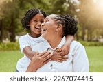Love, family and child and mature woman hug in nature garden and park for affection hugging. Grandchild, grandmother and loving embrace outside in a green field for bonding in summer yard
