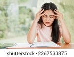 Small photo of Stress, anxiety and worry with a little girl struggling with her studies, education and learning at home. Confused, frustrated and upset student having trouble with homework and difficult study
