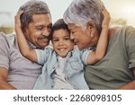Family, portrait and child with grandparents in a living room, hug and happy, love and sweet while bonding in their home. Embrace, grandchild and grandmother with grandfather in a lounge hugging