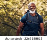 Happy, hiking and portrait of black man in forest for freedom, health and sports training. Exercise, peace and wellness with senior hiker trekking in nature for travel, summer break and adventure
