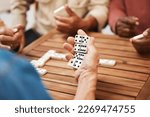 Hands  dominoes and friends in...