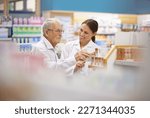 Small photo of Making sure her customers are taken care of. a young pharmacist helping an elderly customer.