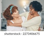 Hug, happy and a mother and daughter with admiration, love and laughing in the living room. Smile, affection and an African mom and woman hugging on mothers day during a visit or reunion together
