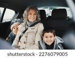 Small photo of Portrait, car ride and grandmother relax with children or grandchildren while travel or on a road trip in the backseat. Bonding, happy and grandma traveling with kids or grandkids on a journey