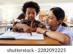Small photo of Teacher, learning and helping black kid in classroom for knowledge, studying or assessment. Question, development and boy or student with woman for education pointing in notebook in kindergarten.