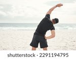 Small photo of Ill reach my fitness goals sooner than later. a young man stretching on the beach.