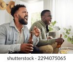 Were winning this one. Shot of two male friends looking cheerful while drinking beers and sitting together.