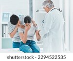 Small photo of The worst day of their lives. Shot of a young couple receiving bad news from their doctor.