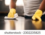 Small photo of Man hands, cleaning gloves and wipe on a table with a wash cloth and housekeeping. Home, countertop and male person with disinfectant and scrub with washing in a apartment with maid and housekeeper