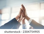 High five, businesspeople and their hands together for cooperation with lens flare. Collaboration or teamwork, group or coworkers support and people with hand in air for unity or achievement