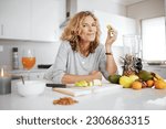 Portrait, fruit salad and apple with a senior woman in the kitchen of her home for health, diet or nutrition. Smile, food and cooking with a happy mature female pension eating healthy in the house