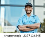 Happy man, portrait and security guard with arms crossed in city for career safety or outdoor protection. Male person, police or officer smile in confidence, law enforcement or patrol in urban town