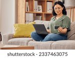 Laptop, credit card and woman of home online shopping, e commerce or fintech payment on sofa. Relax, loan and happy person on internet banking, e learning subscription and computer or web transaction