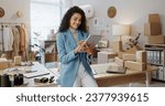 Small photo of Happy woman, fashion designer and tablet in logistics or small business management at boutique. Female person or entrepreneur smile with technology in supply chain, stock or shipping at retail store